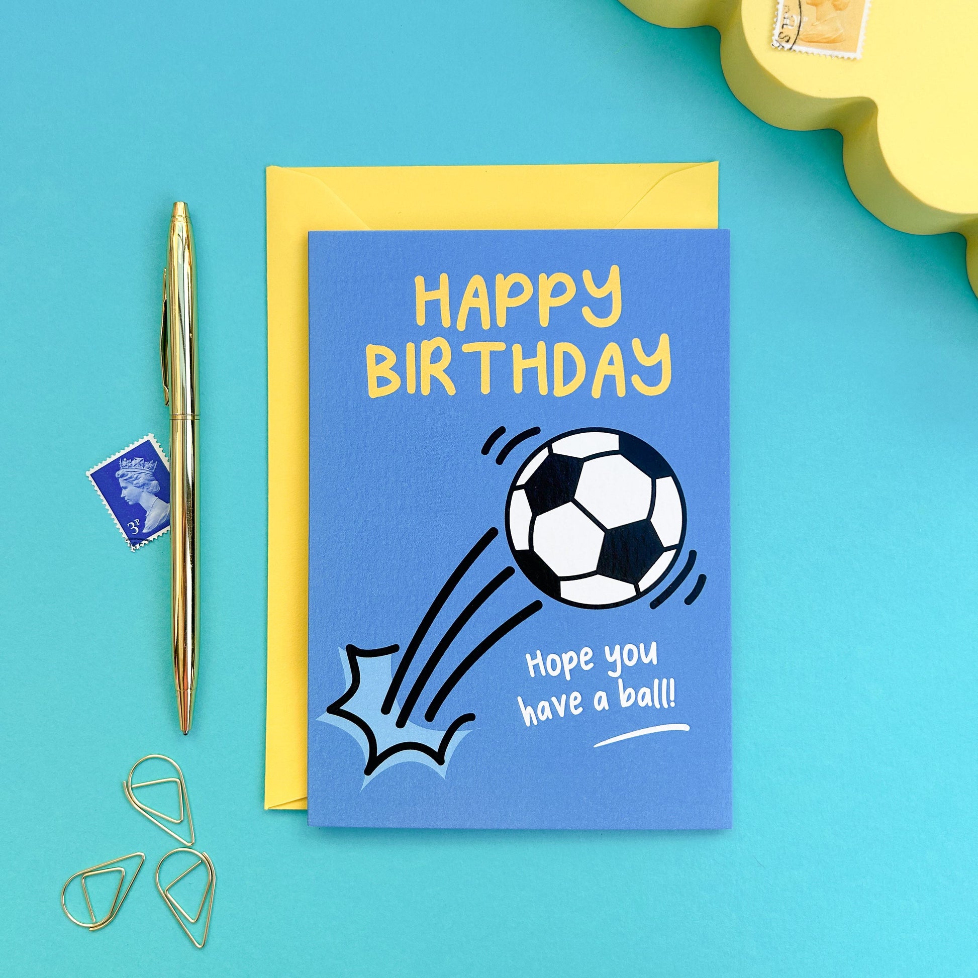 Blue birthday card with soccer ball graphic and 'Happy Birthday' text on a blue background