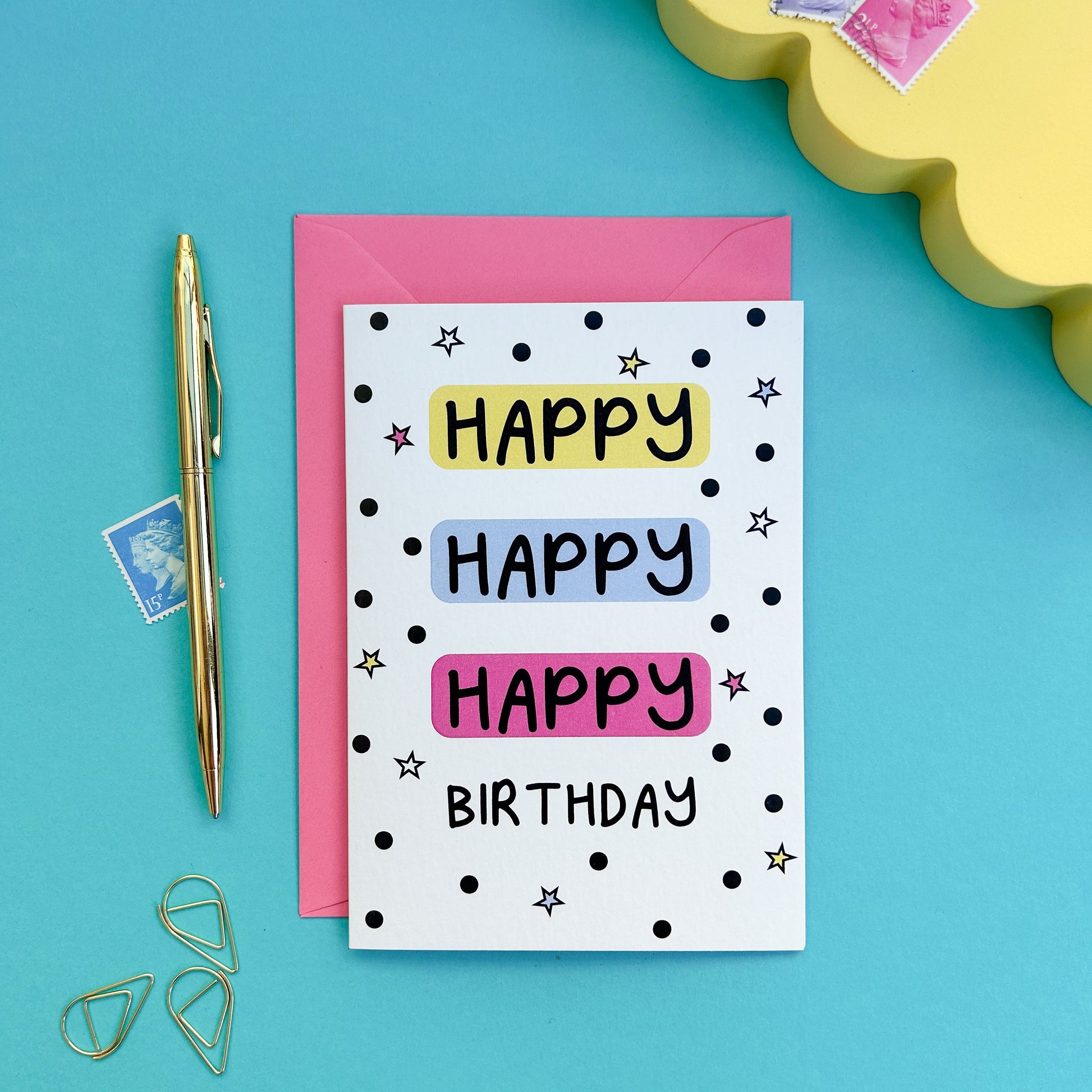 Greeting card with 'Happy Happy Birthday' text on a white background with black spots and stars around